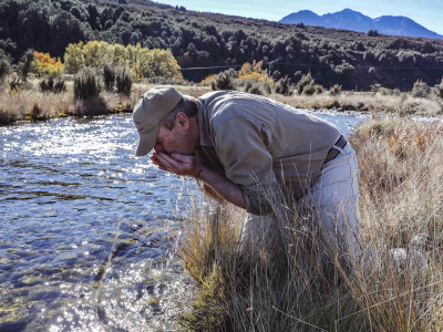 Manuka Points Don Patterson has a drink from a stream on his property