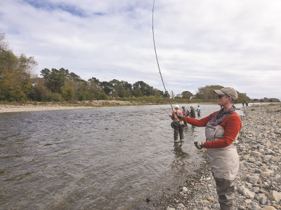 Nancy concentrates as she practices casting at Otaki River during a Women on the Fly class.