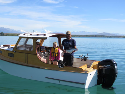 WFR2526.131 Angler Casey Dixon with a well conditioned rainbow trout with his daughter Bella and wife Ashley, enjoying all Lake Benmore has to offer.
