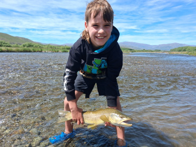 WFR2526.64 Sefton Stevens, age 8, about to release a Tekapo River brown that succumbed to a well presented soft bait.