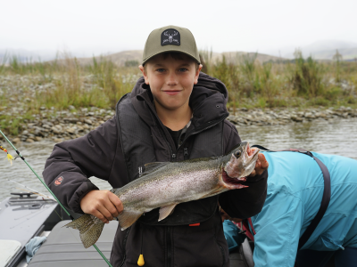 Robbie Lane, age 11 with his Waitaki rainbow trout for the table caught off his grandparents jetboat with a tassie devil lure.