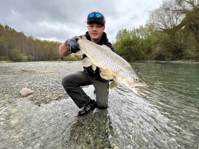 WFR2526.12 Sam Coskerie presents one of several fine brown trout he has caught in the last week