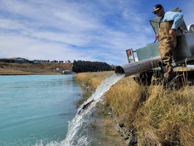 WFR2122.53 Fish Game Officer Hamish Stevens releasing sports fish to the Tekapo Canal Photo Credit Rhys Adams