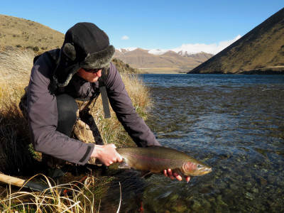 WFR1819.10Fish Game Officer Hamish Stevens display a large Lake Heron rainbow credit R Adams