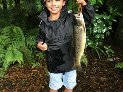 TRL1Jan18. Malakai Martin Capper proudly shows off a brown trout caught during a fresh in the lower Waiwhakiaho River photo Les Martin.