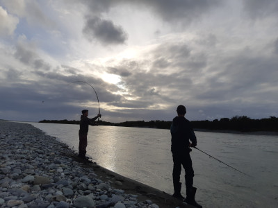 Josh Blyth and Harrison Calder salmon fishing in the Taramakau River Monday evening. Photo Baylee Kersten
