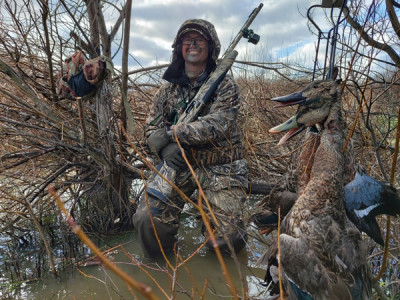 Nathan Field having a ball shooting some flooded woodland from a makeshift hide