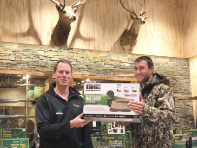 Scott Fraser from Waikato Hunting Fishing hands Alan Betschart his prizes.