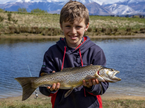 FGNZ7385a Nine year old Blake Marrett had success with wormfishing on Lake Opuha with this lovely brown trout